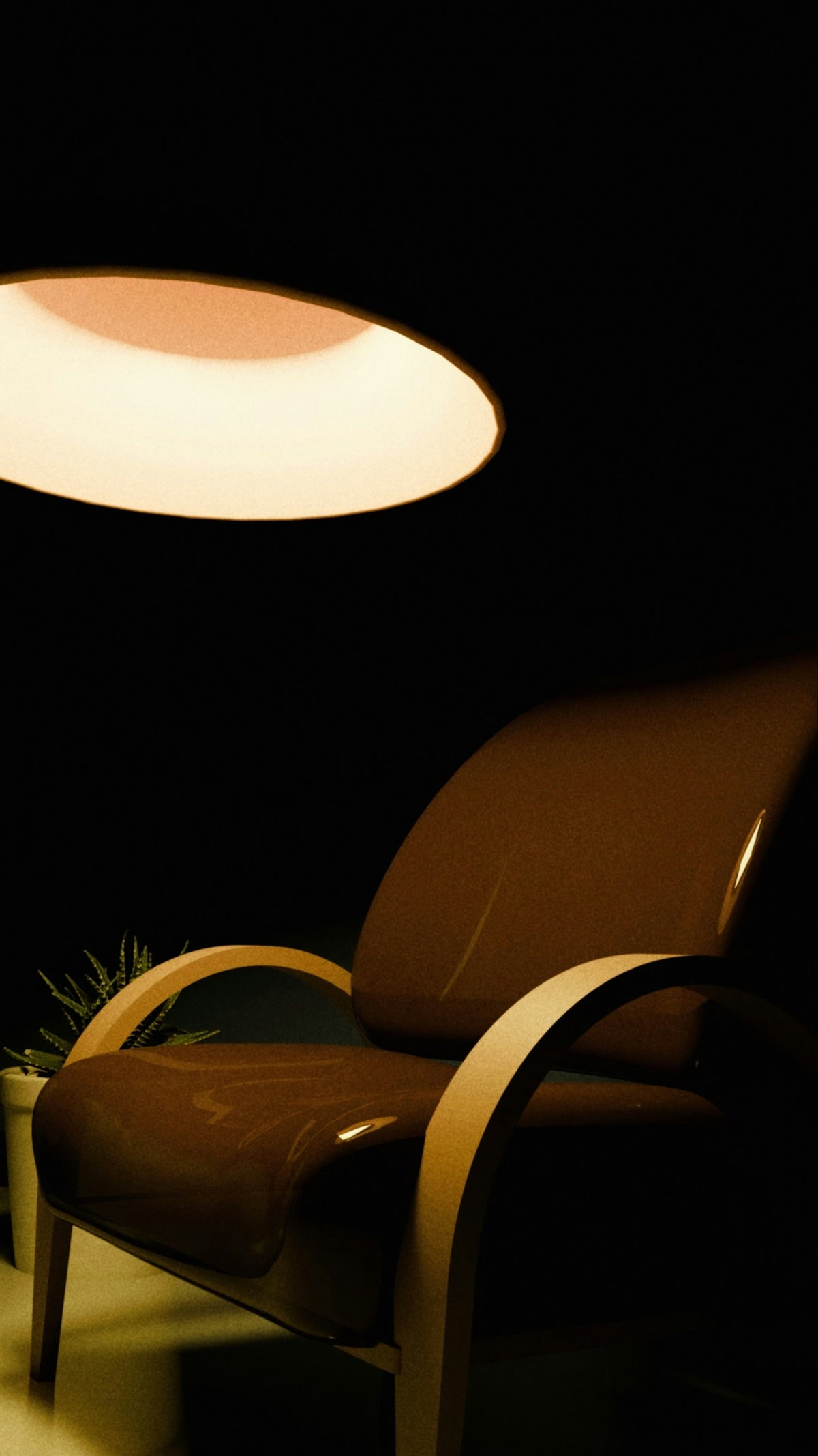 Poltrona illuminata da una lampada a sospensione
